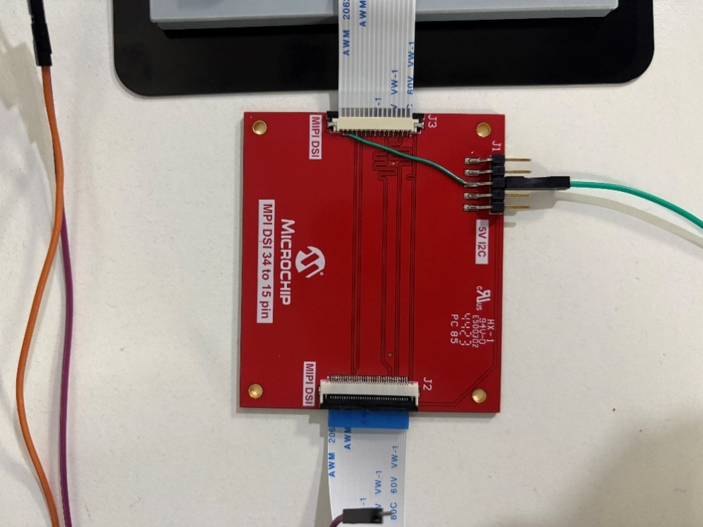 A red rectangular object with wires connected to it AI-generated content may be incorrect.